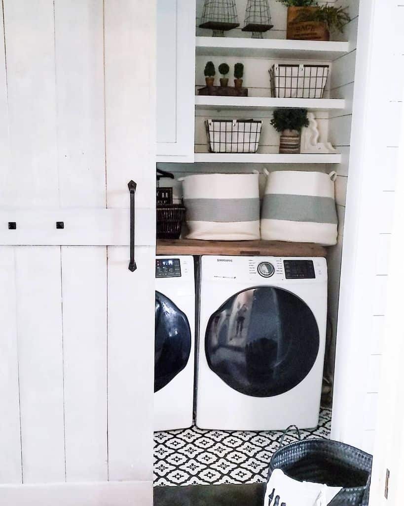 farmhouse laundry room with white sliding barn door