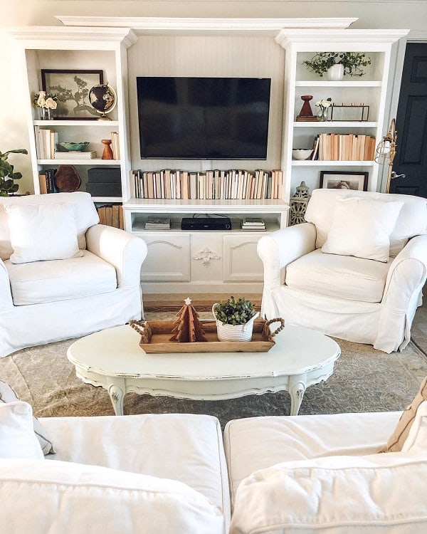 farmhouse living room entertainment center wall mounted tv two sofas white bookshelf 