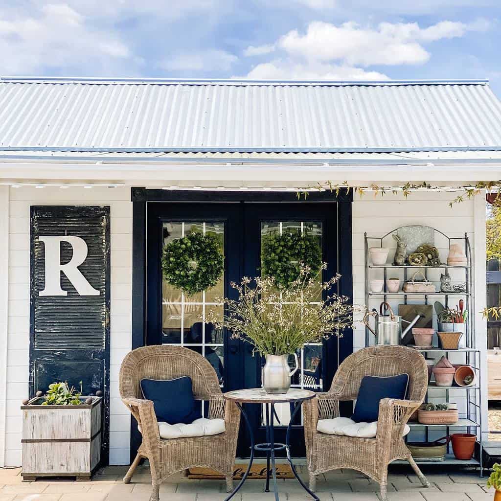 farmhouse she shed with wicker chairs and table 