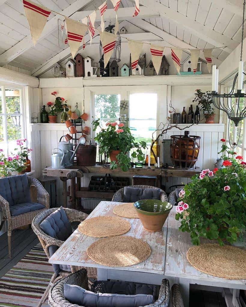 large farmhouse she shed with work bench and table with chairs 