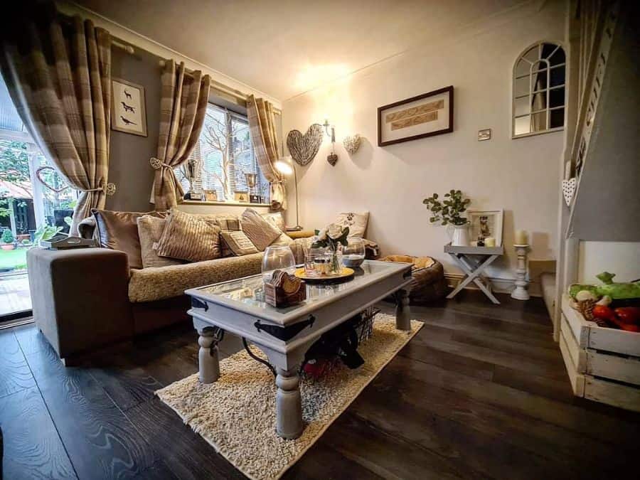 farmhouse living room with gray glass coffee table and brown sofa