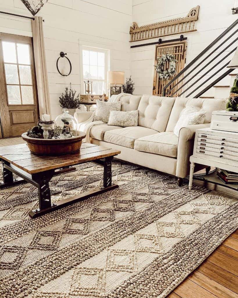 country chic farmhouse living room with white shiplap walls and wood coffee table