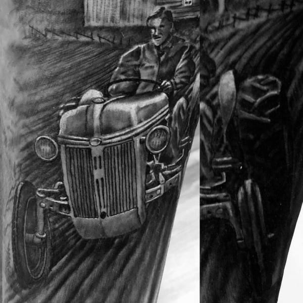 Realistic black and gray tattoo of a man driving a vintage tractor through a plowed field, with detailed shading and motion lines.