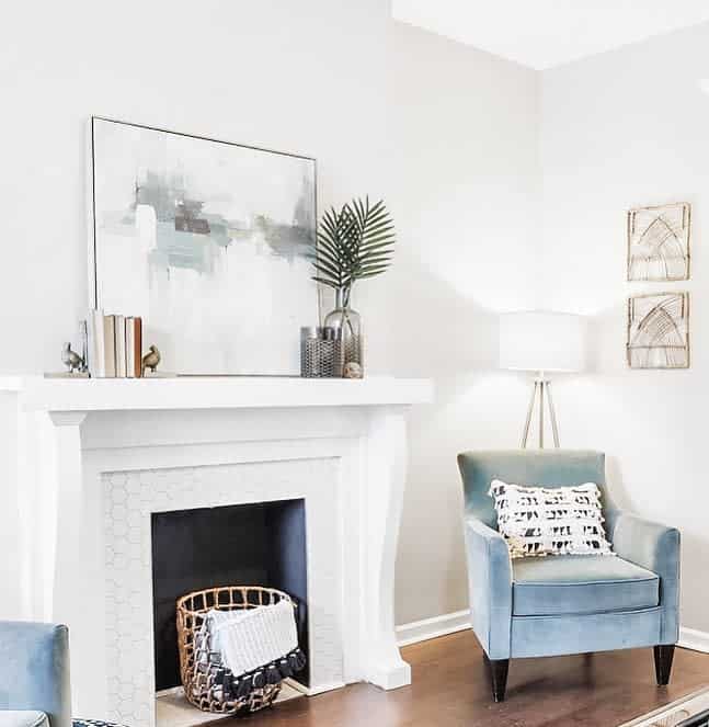white faux fireplace blue accent chair