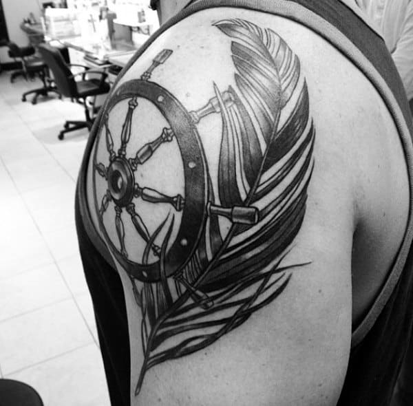 Feather And Ship Wheel Black Ink Tattoo For Males On Shoulder