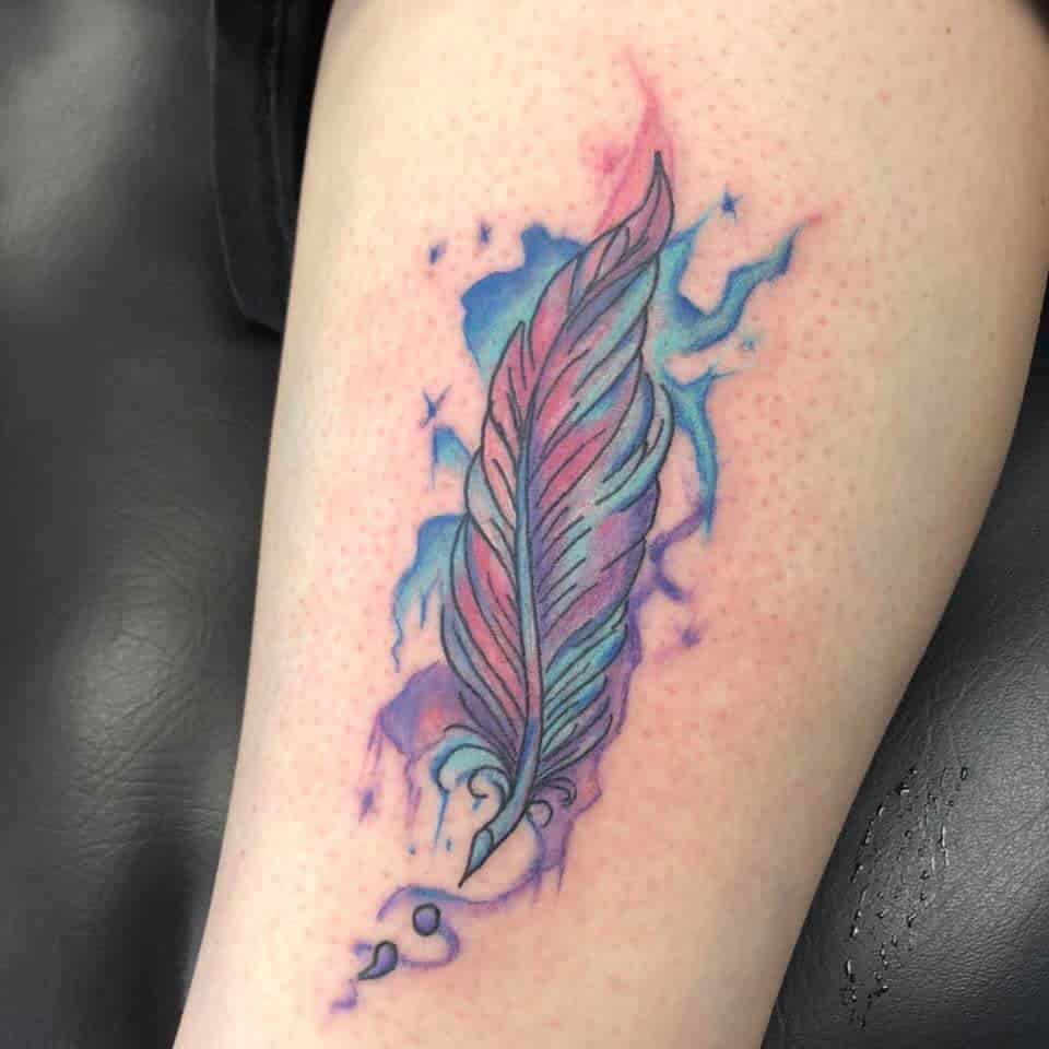 Colorful feather and semicolon tattoo on skin with blue and purple watercolor background on arm