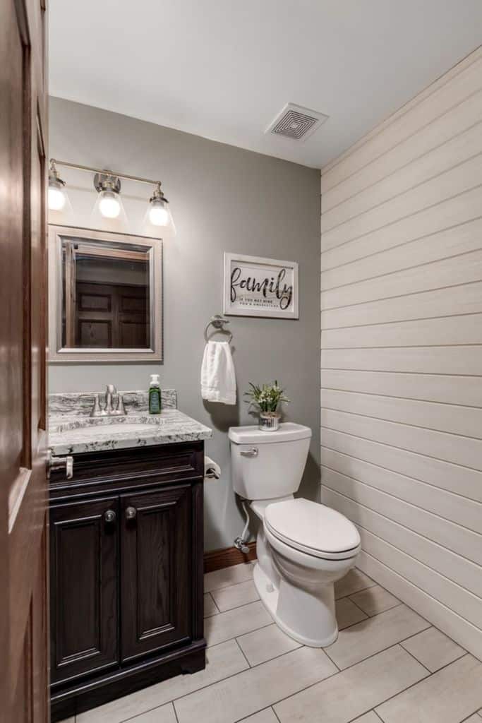 white shiplap accent wall small bathroom 