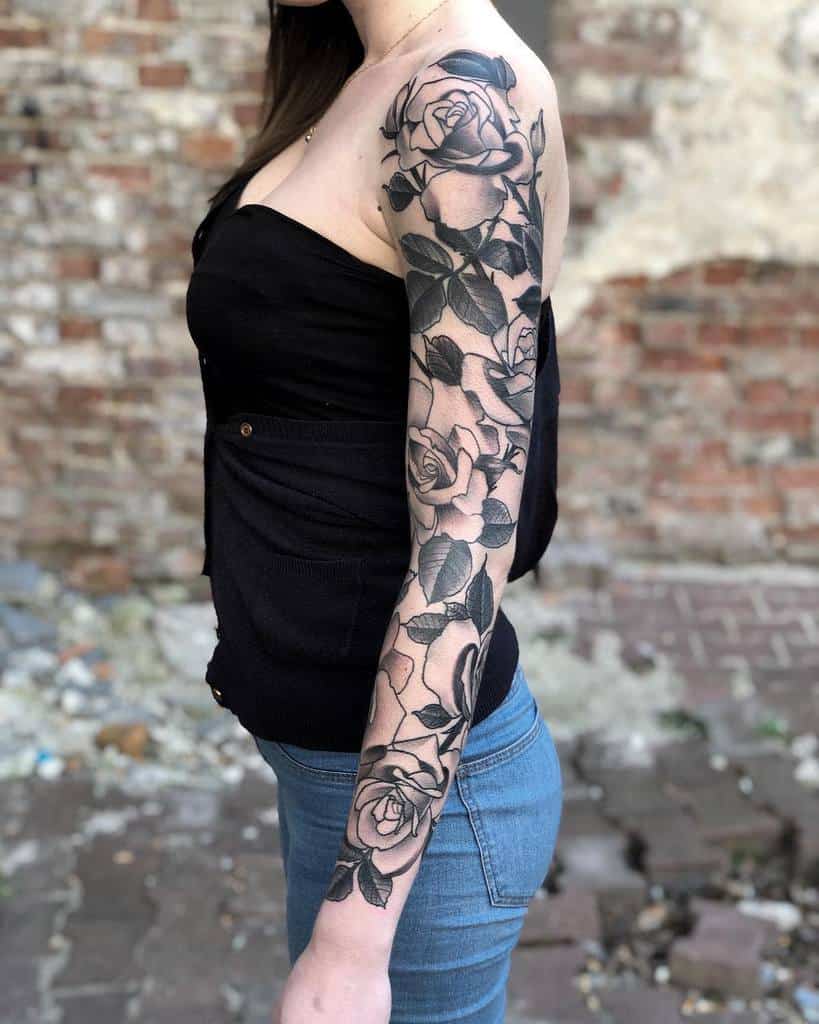 A woman with a stunning full sleeve rose tatto