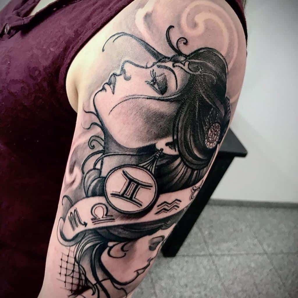 Black and grey tattoo of a two mystical woman with flowing hair, adorned with zodiac symbols, including Gemini, Scorpio, Libra, and Aquarius