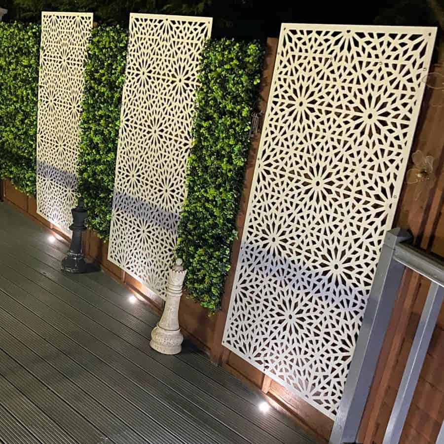 white lattice fence idea with bush gray deck