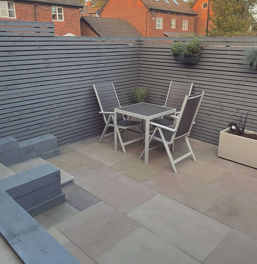 small concrete paver patio with table and chairs 