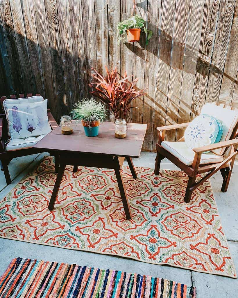 vintage table and chairs on pattern rug backyard patio