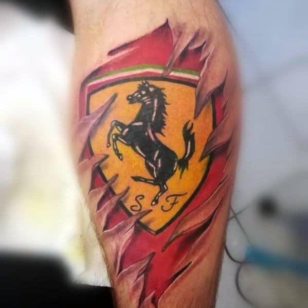 Dynamic Ferrari emblem tattoo with a ripped-skin effect revealing a vibrant prancing horse shield beneath, inked on man's leg.
