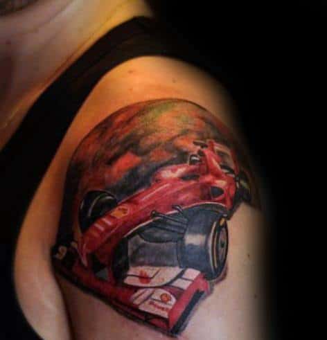 Vivid Ferrari Formula 1 car tattoo on man's upper arm, capturing speed, adrenaline, and racing spirit.