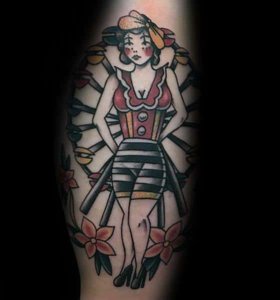 Vintage-inspired Ferris wheel tattoo featuring a pin-up style woman integrated into the ride, with bold colors, floral accents, and retro details.