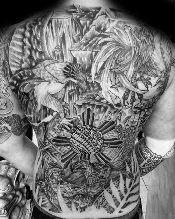 Full-back Filipino tattoo featuring the sun with tribal rays, the Philippine eagle, mythological elements, and nature-inspired details.