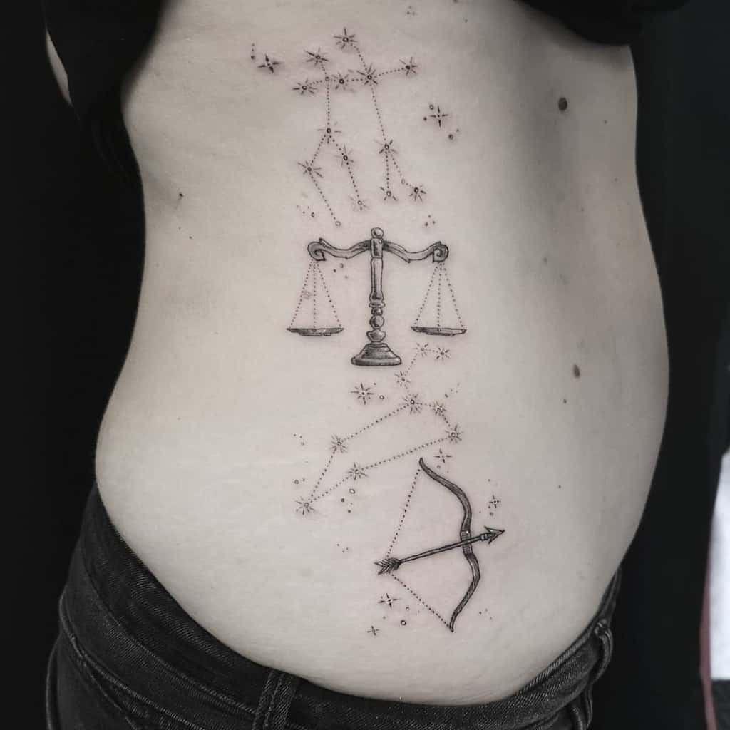 Minimalist zodiac tattoo with Libra’s scales and Sagittarius’ bow, surrounded by starry constellations along the ribcage.