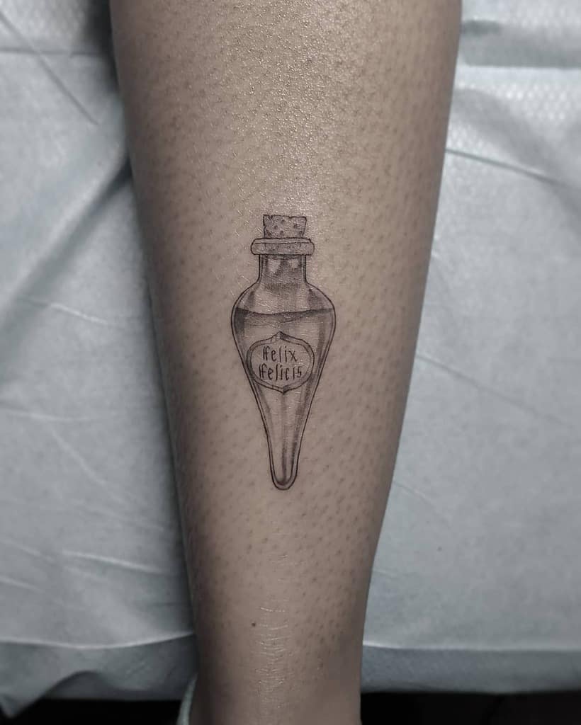 Minimalist Harry Potter tattoo of a Felix Felicis potion bottle, finely detailed with delicate linework