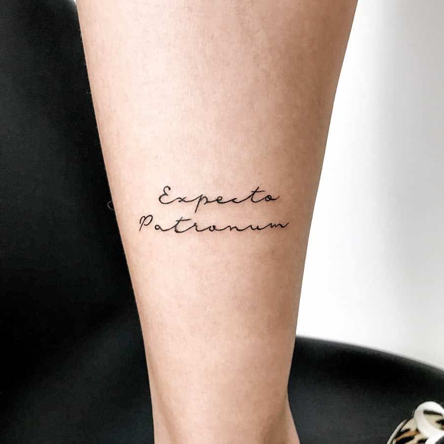 Elegant Harry Potter tattoo of 'Expecto Patronum' in delicate cursive script, symbolizing protection