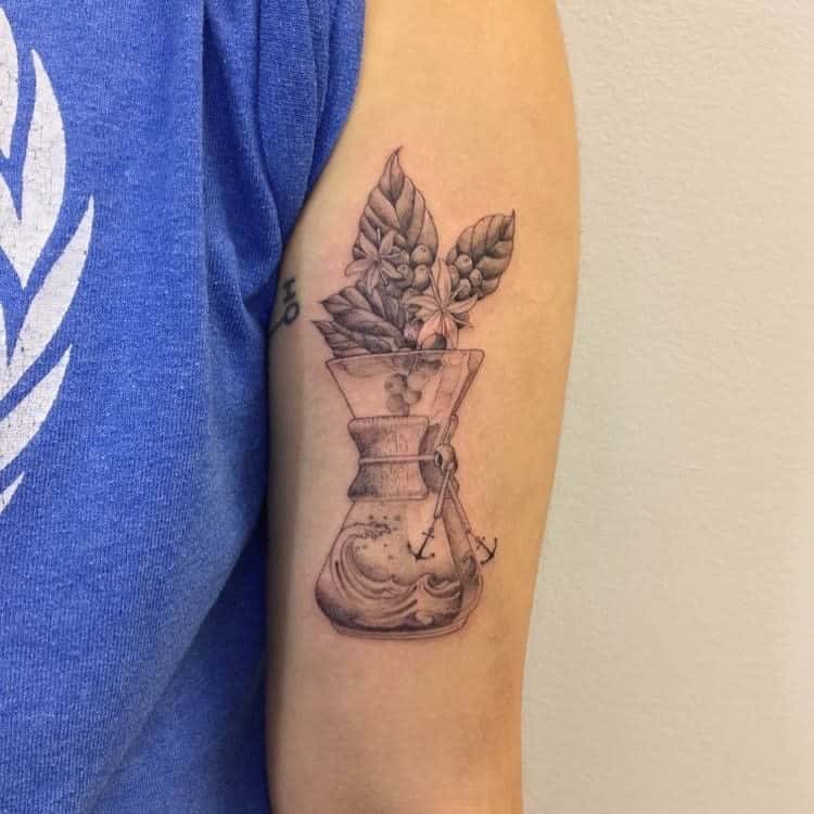Tattoo of a plant in a glass jar with liquid, located on a person's upper arm, intricately done using single needle technique