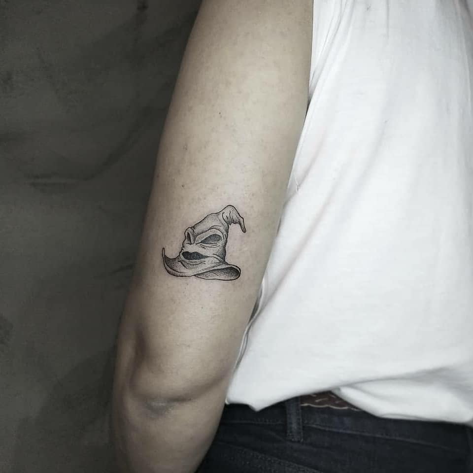 Minimalist Sorting Hat tattoo, inspired by Harry Potter, symbolizing wisdom, fate, and the Hogwarts house selection