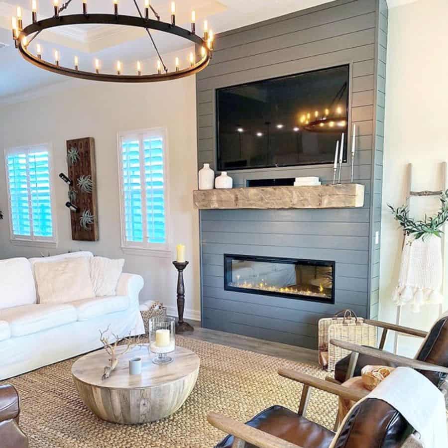 farmhouse living room white sofa brown accent chairs gray shiplap electric fireplace