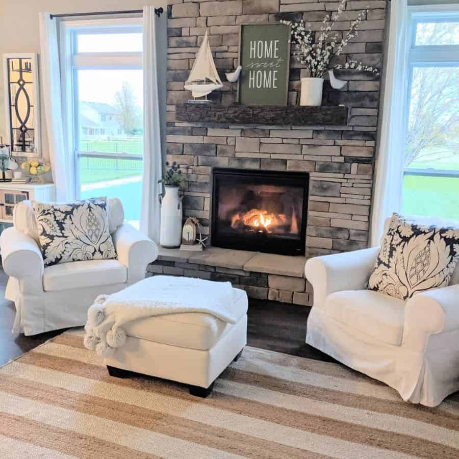 stone fireplace white lounges ottoman floor rug