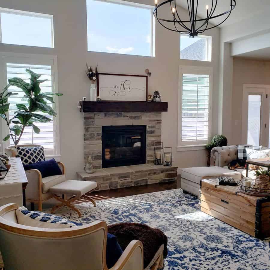 modern living room stone fireplace chandelier wood chest blue pattern rug sofa