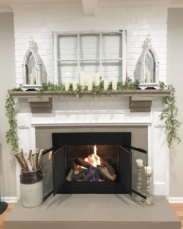 white brick fireplace with gray mantel with candles
