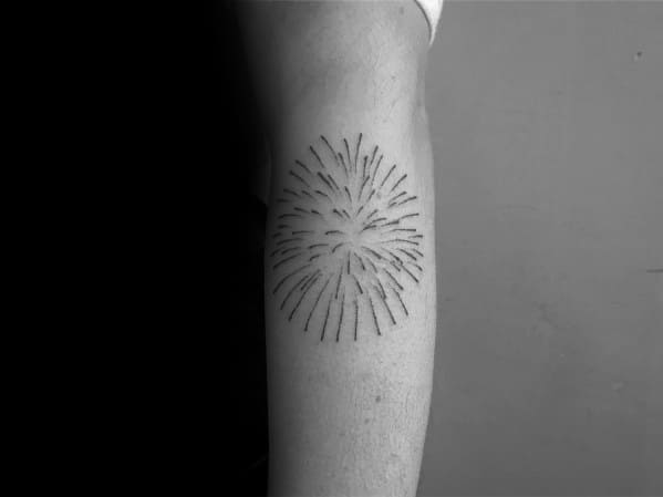 Minimalist black ink tattoo of a firework explosion, featuring fine lines radiating outward for a simple yet elegant design.