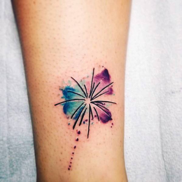 Minimalist firework tattoo with fine black lines and a watercolor-style burst of blue and purple, creating a soft and artistic effect.