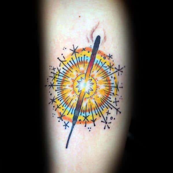 Tattoo of a glowing sparkler with bright yellow and orange bursts, surrounded by intricate spark details for a dynamic and festive design.
