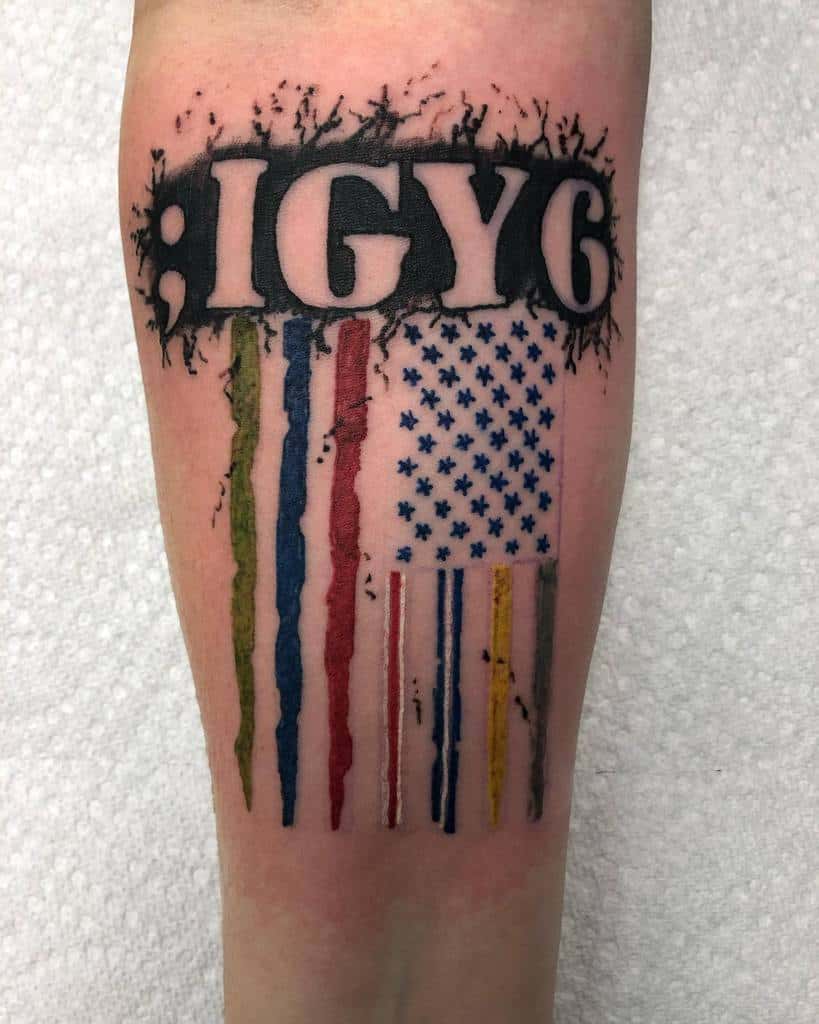Tattoo with ";IGY6" and weathered American flag design featuring colored stripes in red, white, blue, green, and yellow