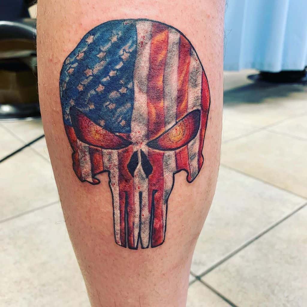 Punisher Skull tattoo with an American flag pattern, featuring intense fiery eyes, blending patriotism with a fierce, bold design