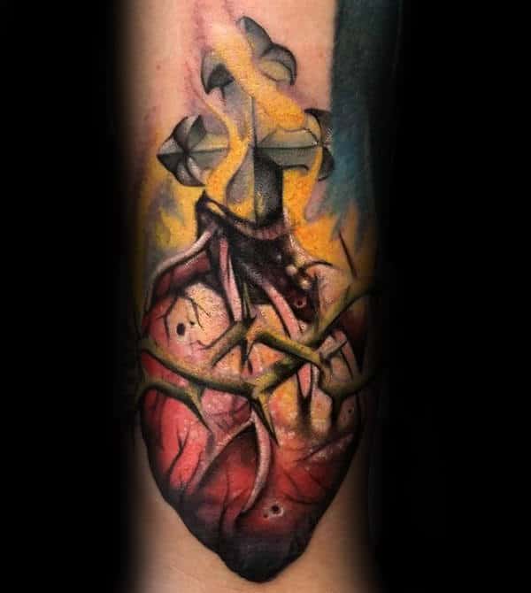 Realistic heart tattoo with a cross, thorns, and flames in vibrant colors.