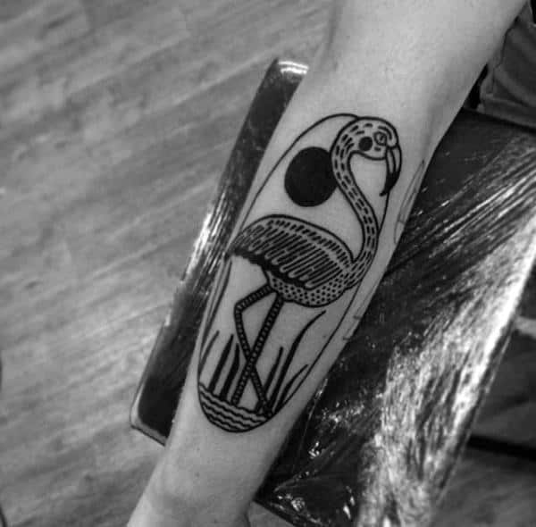 Bold blackwork flamingo tattoo with thick outlines, geometric patterns, and a sun backdrop, creating a striking and graphic aesthetic.