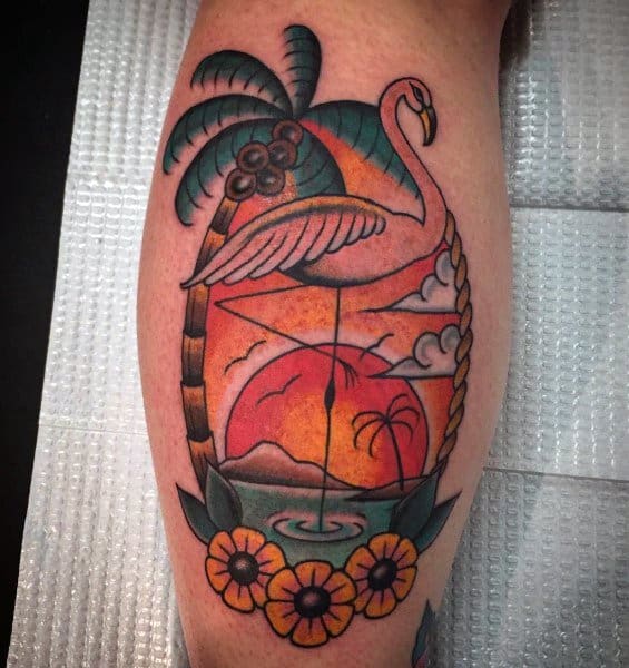 Traditional-style flamingo tattoo with a tropical sunset, palm trees, and vibrant floral details, creating a bold and colorful beach-inspired design.