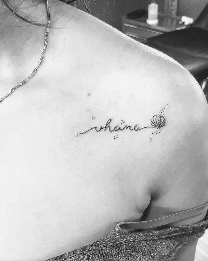 Delicate 'Ohana' tattoo with a seashell accent, symbolizing family, connection, and a love for the ocean.