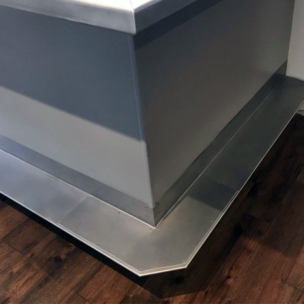 Stainless steel flat foot rail with modern design around a bar on dark wooden flooring.