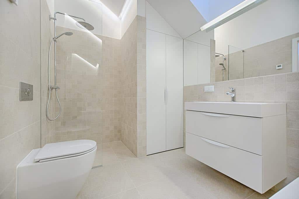 Spacious modern bathroom with glass shower, floating vanity, and minimalist design.