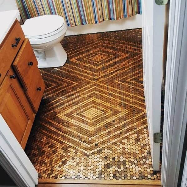 Bathroom with penny tile floor featuring a diamond geometric pattern and wooden vanity.
