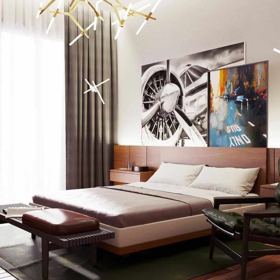 Contemporary bedroom with plane artwork, abstract light fixtures, and floor-to-ceiling curtains.