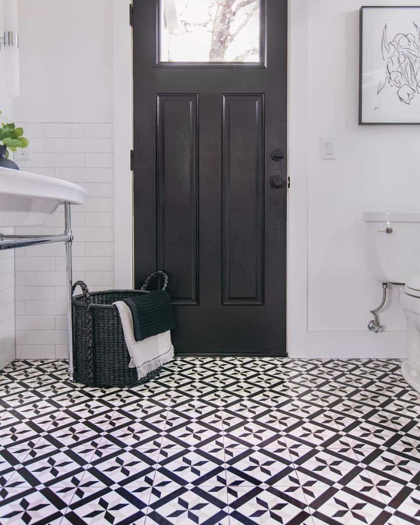 pattern tile powder room with black door 