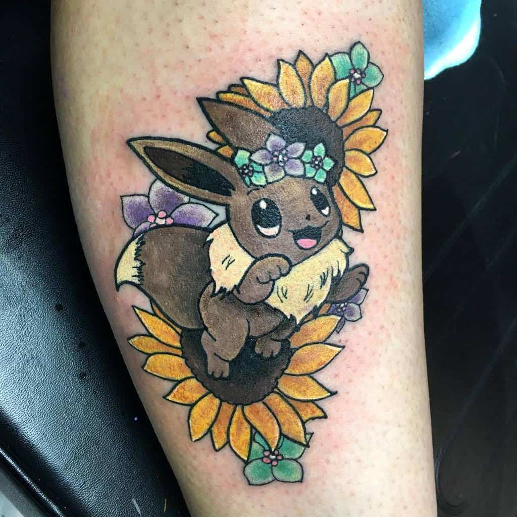 Cheerful Eevee tattoo adorned with a floral crown, surrounded by vibrant sunflowers and soft purple blossoms