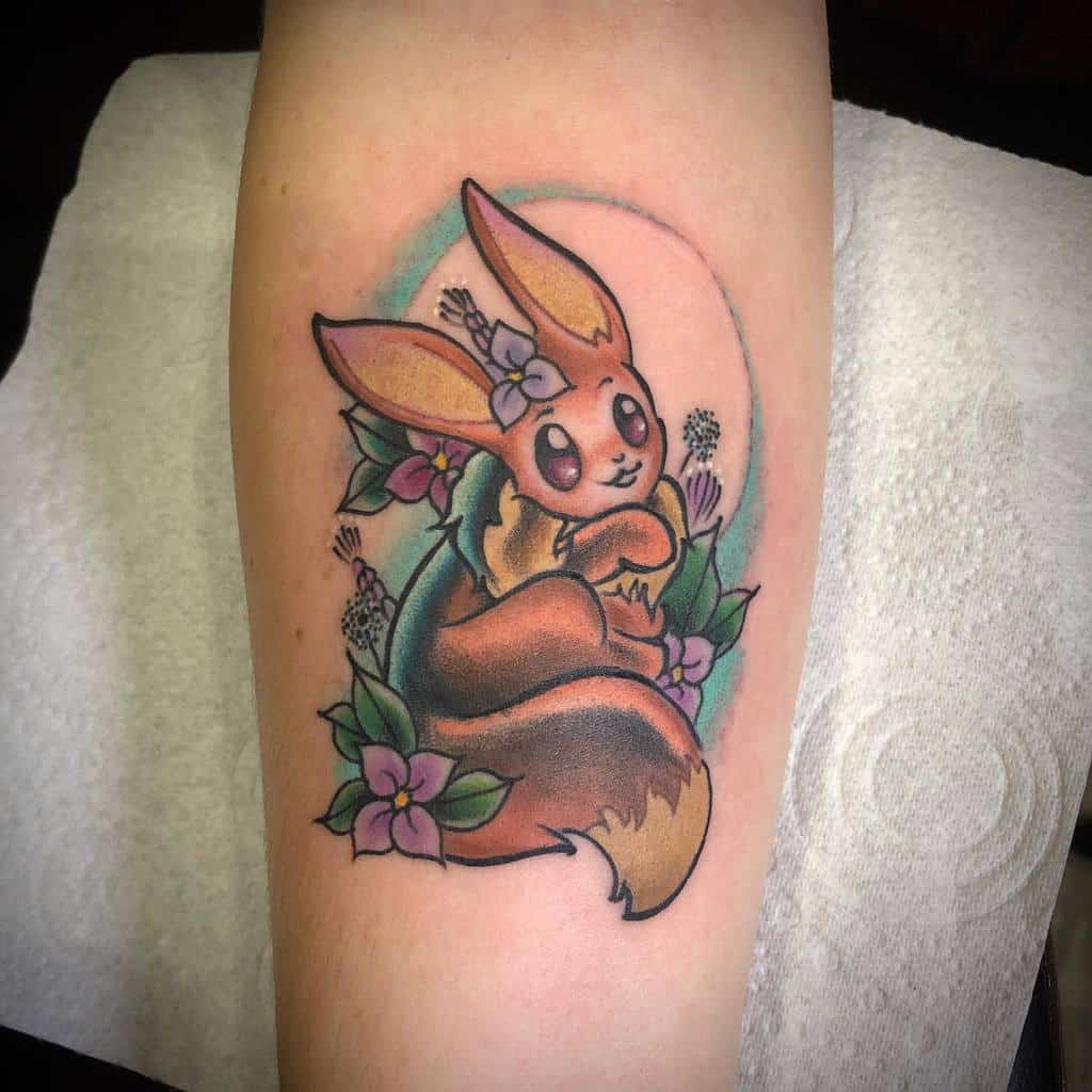 Delightful Eevee tattoo with a floral crown, surrounded by lavender and violet blooms, set against a soft pastel background