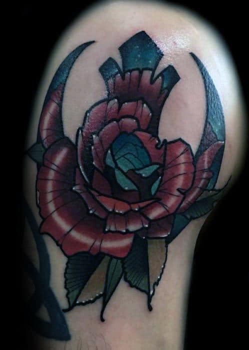 Colorful Rebel Alliance tattoo on the upper arm, featuring a detailed red rose in the center.