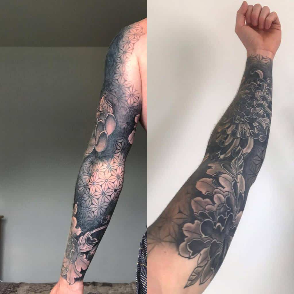 Intricate floral sleeve tattoo on left arm, featuring geometric patterns and blossoming flowers