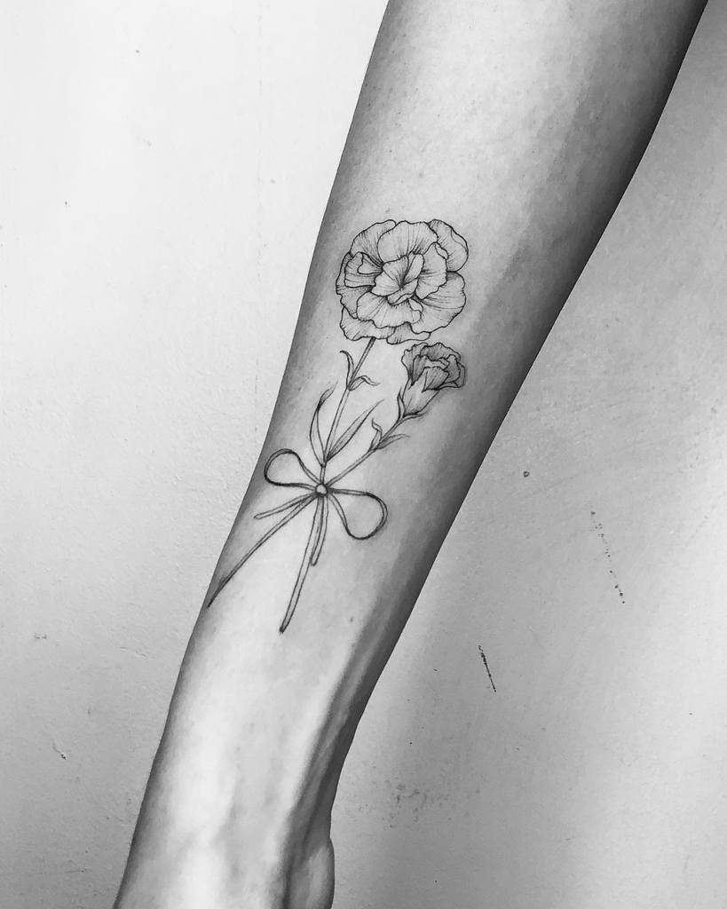 Black and white tattoo of two carnation with a bow 