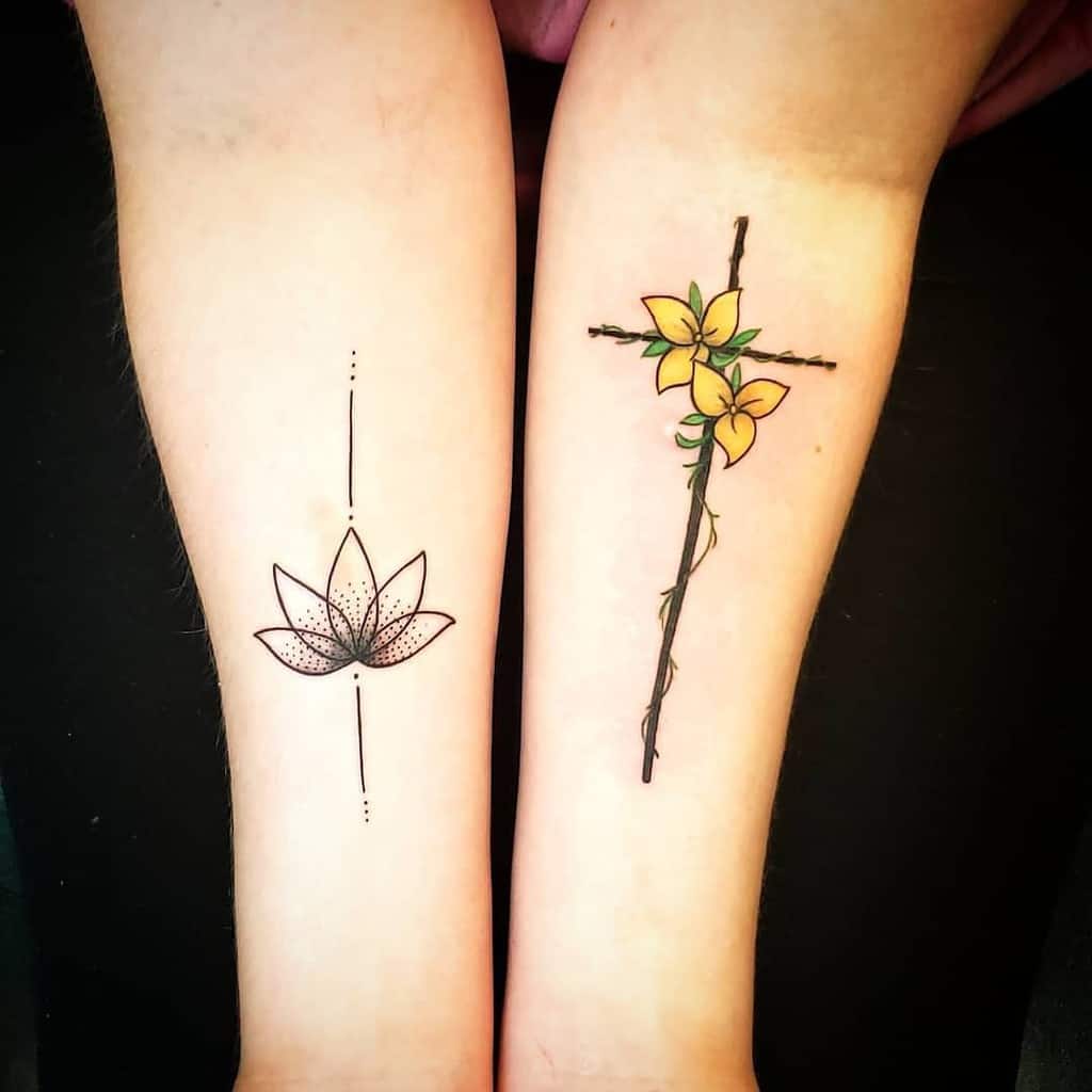 Two forearms showcase tattoos: one decorated with a serene lotus flower, while the other features a cross intertwined with vibrant yellow flowers