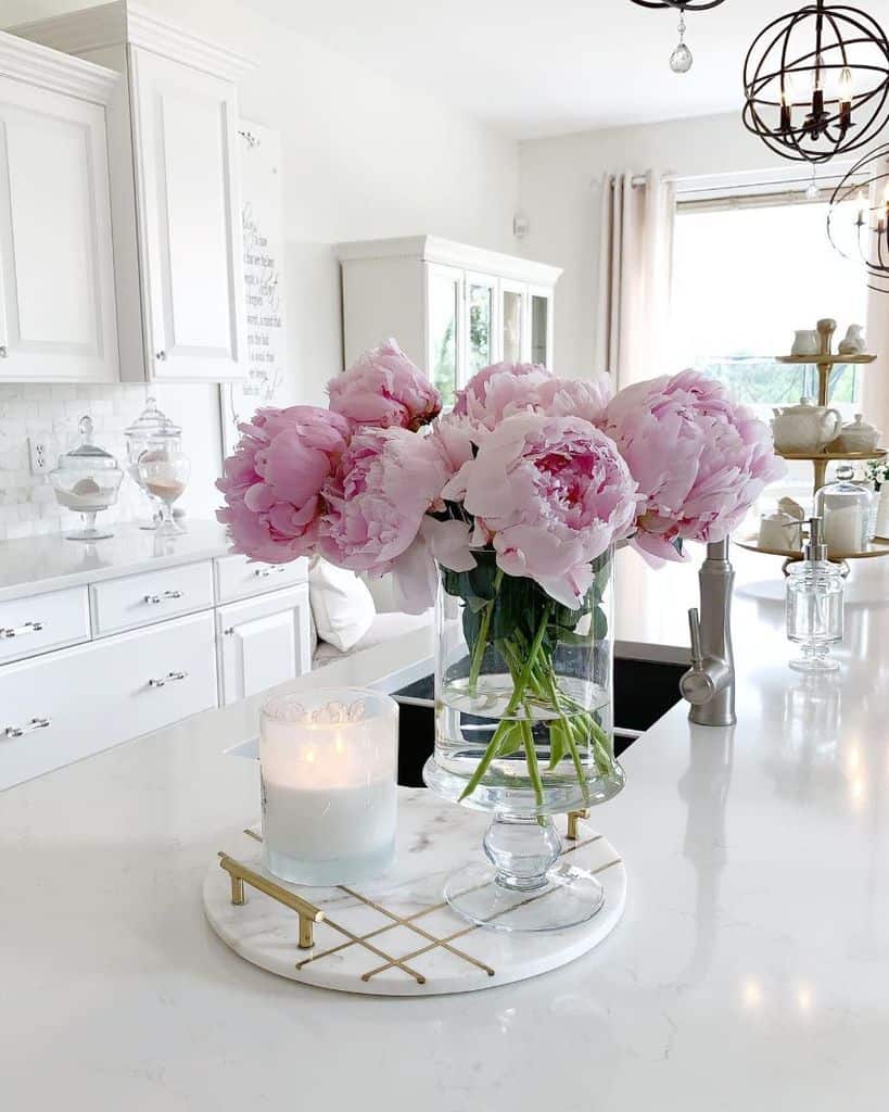white kitchen pink roses in glass vase candle